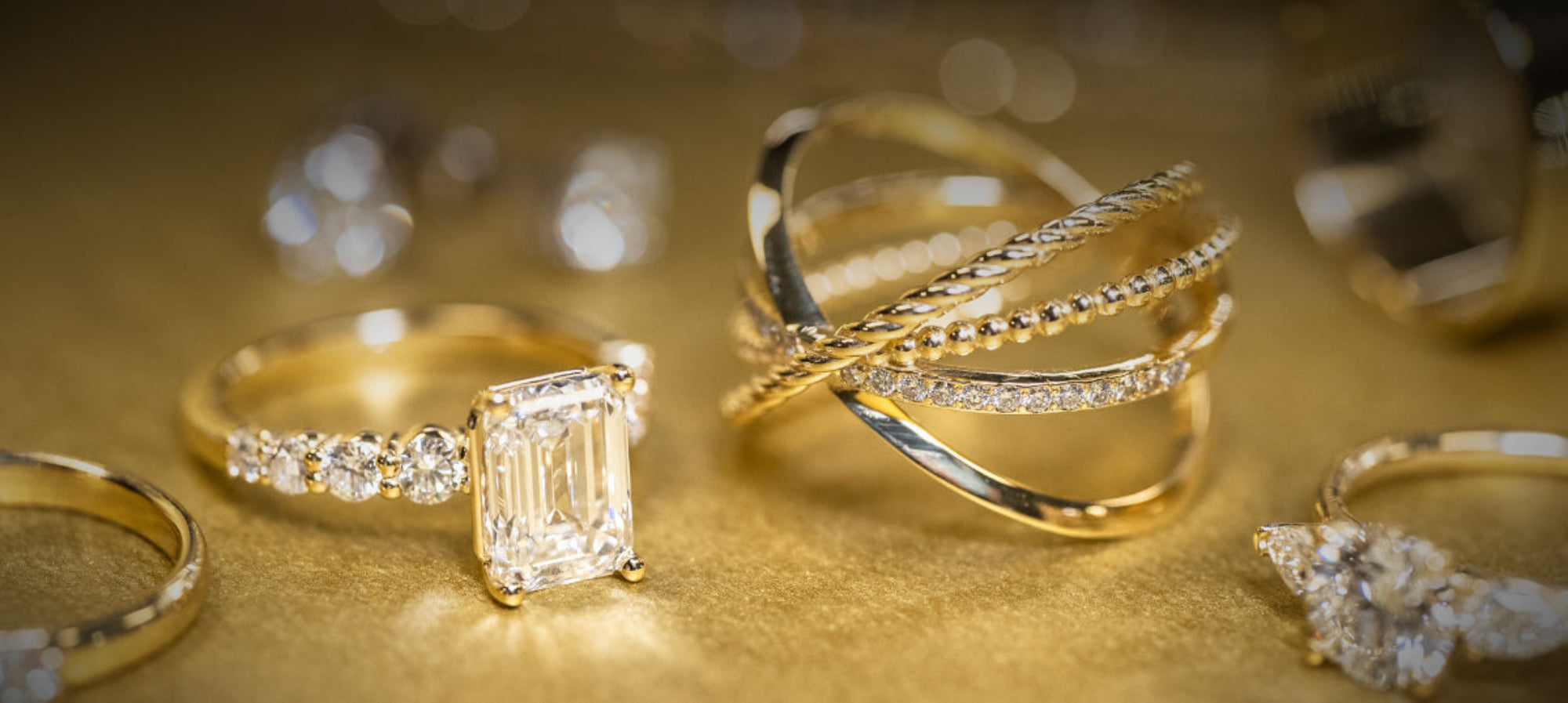 Gold rings with diamonds on a gold background